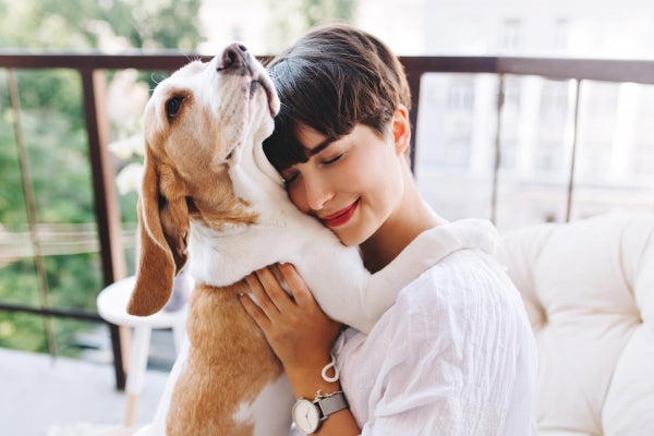 close-up-portrait-pleased-girl-with-short-brown-hair-embracing-funny-beagle-dog-with-eyes-closed